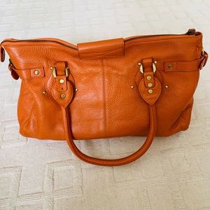 Orange leather bag.